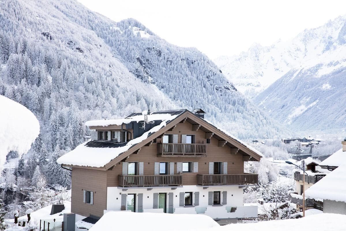 Chalet exterior with multiple private balconies and mountain views