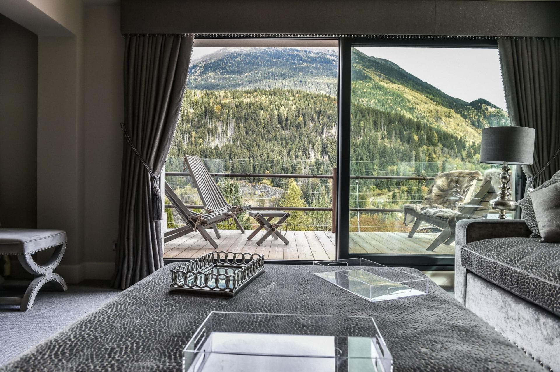 Living area with floor-to-ceiling windows and private deck access