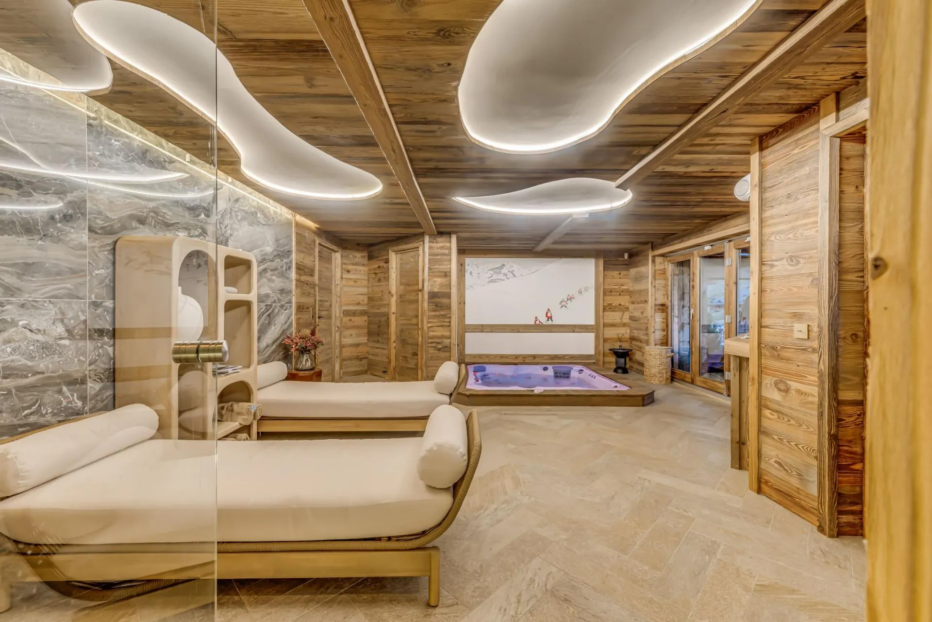 Indoor spa with sunken hot tub and lounge daybeds
