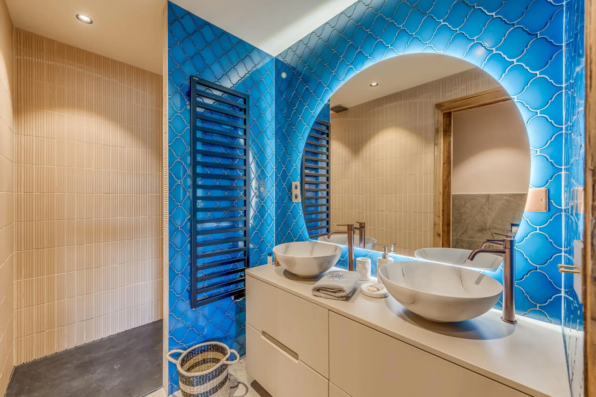 Bathroom with dual vessel sinks and heated towel rack