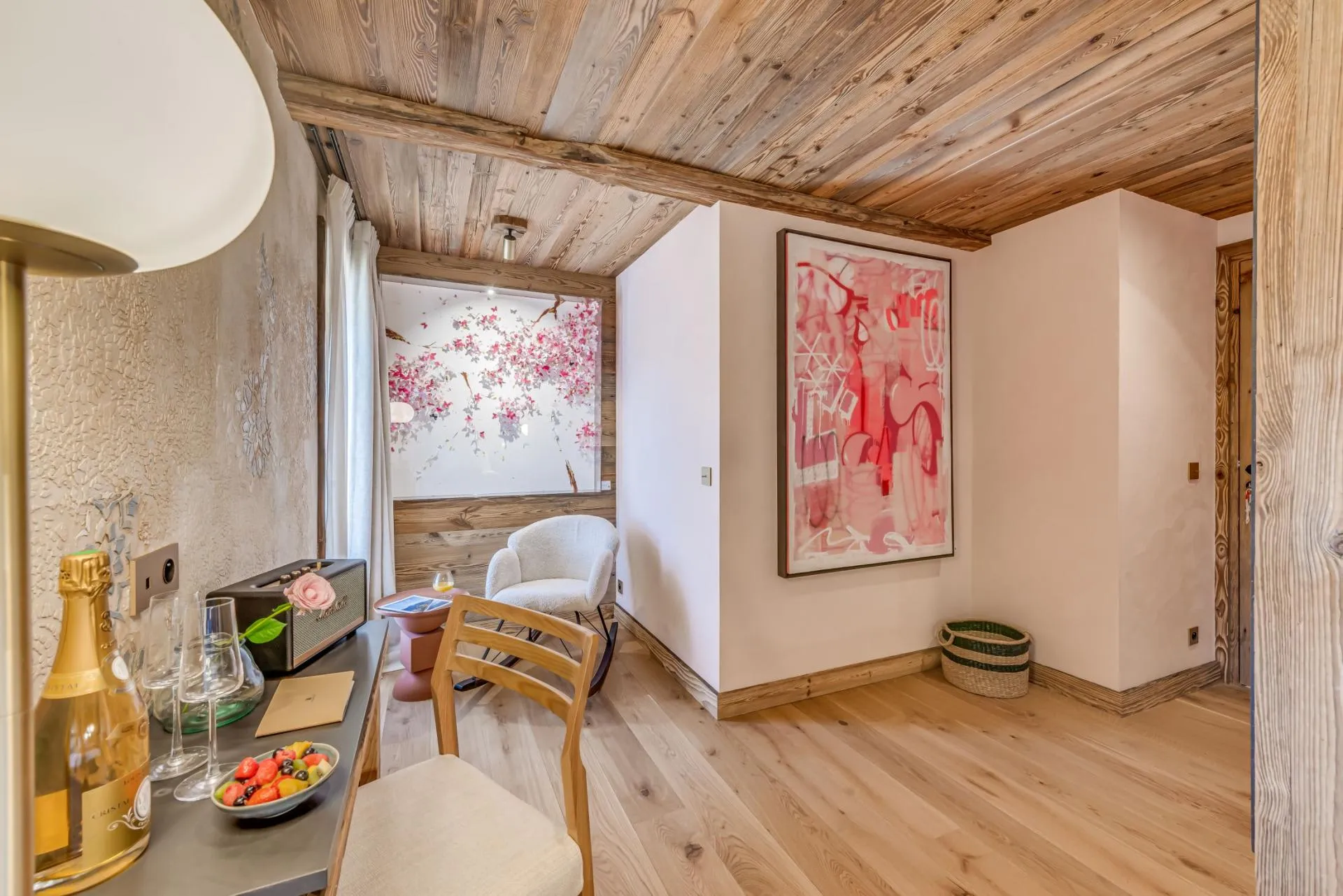 Bedroom nook with desk, Marshall speaker, and wood-beamed ceiling
