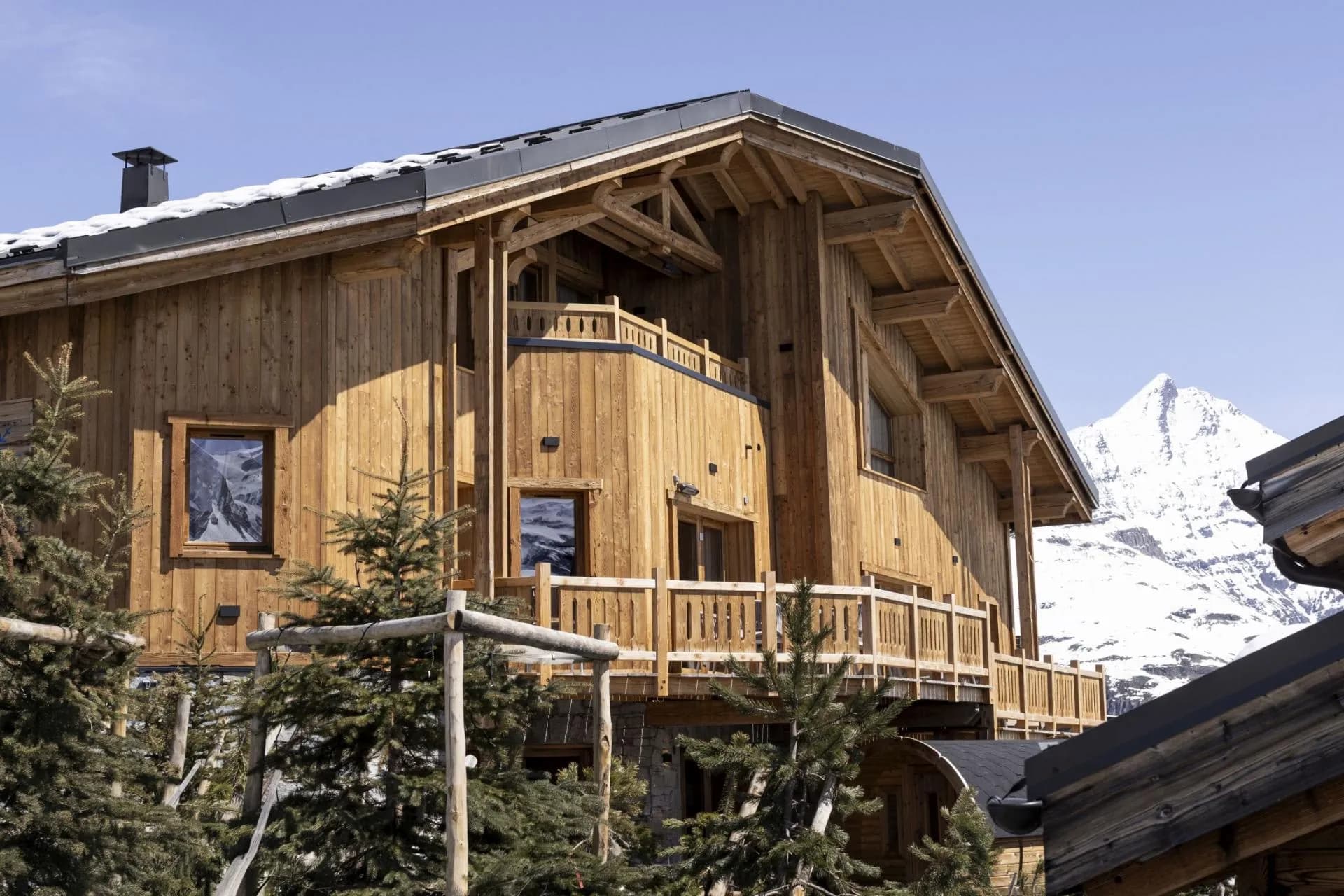 Timber chalet exterior with private balconies and mountain views