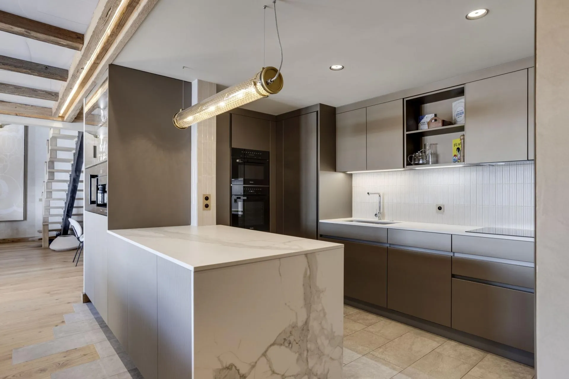 Kitchen with waterfall island and built-in espresso machine
