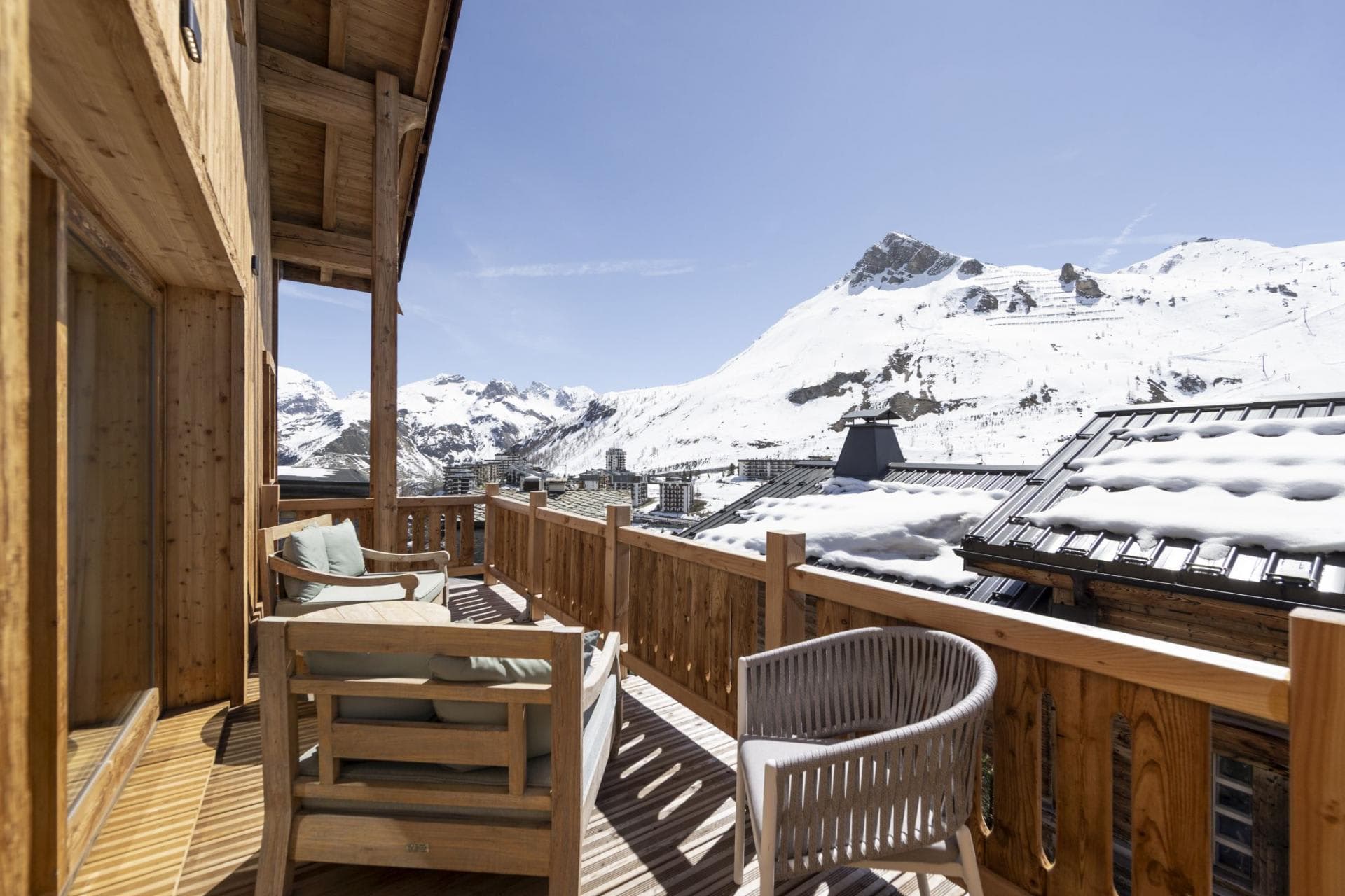 Private wooden balcony with lounge seating and mountain peak views