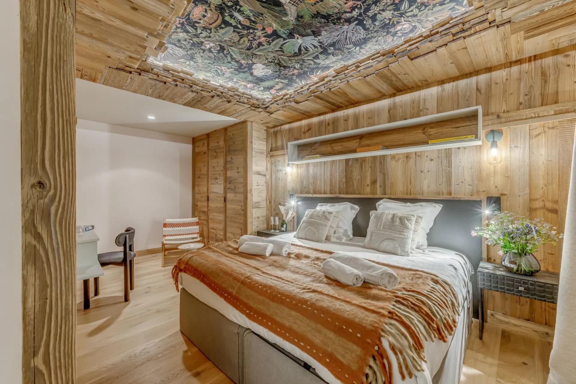 Bedroom with king bed and floral ceiling mural
