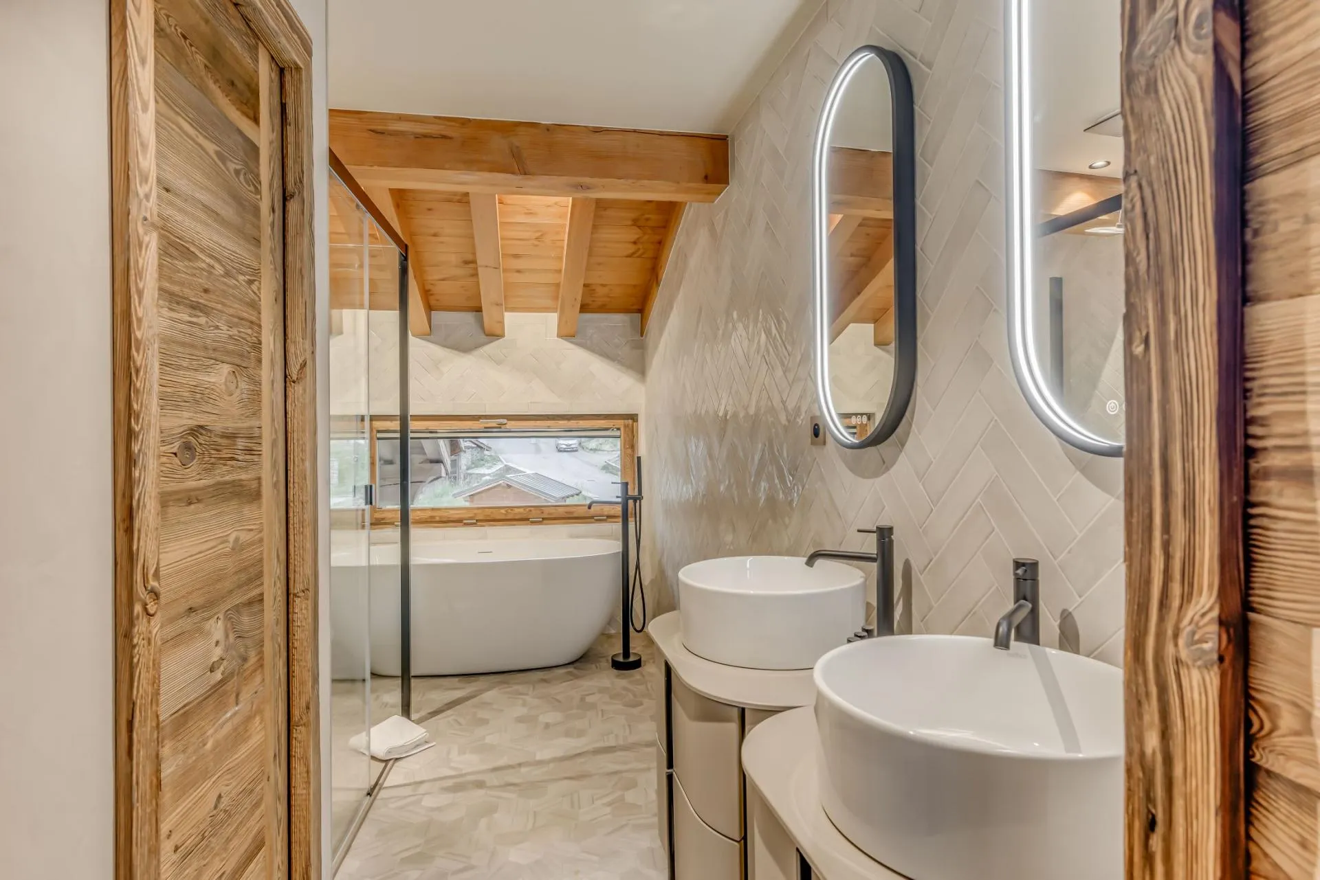 Bathroom with dual vanity, soaking tub, and walk-in shower