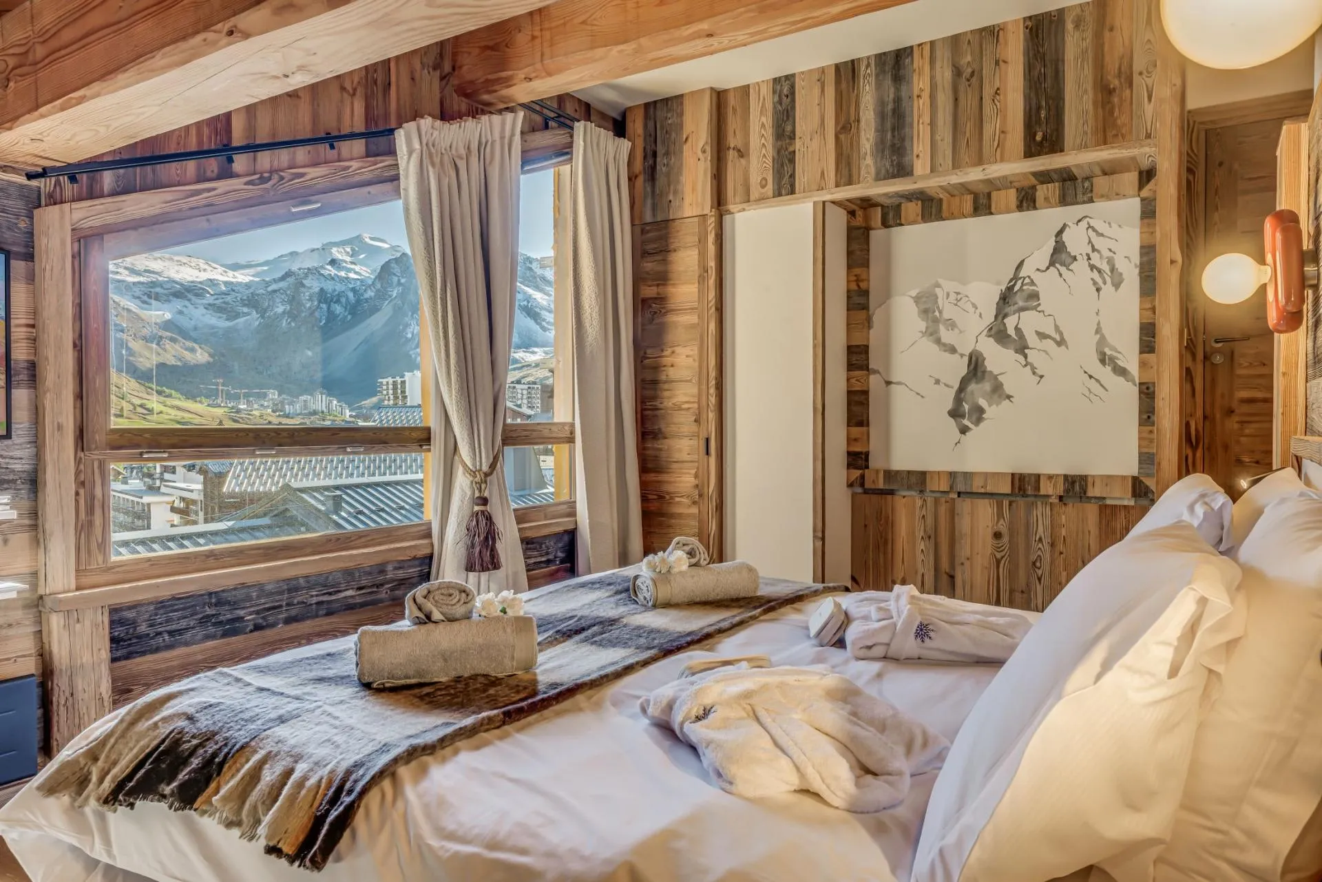 Bedroom with king bed and snow-capped mountain views