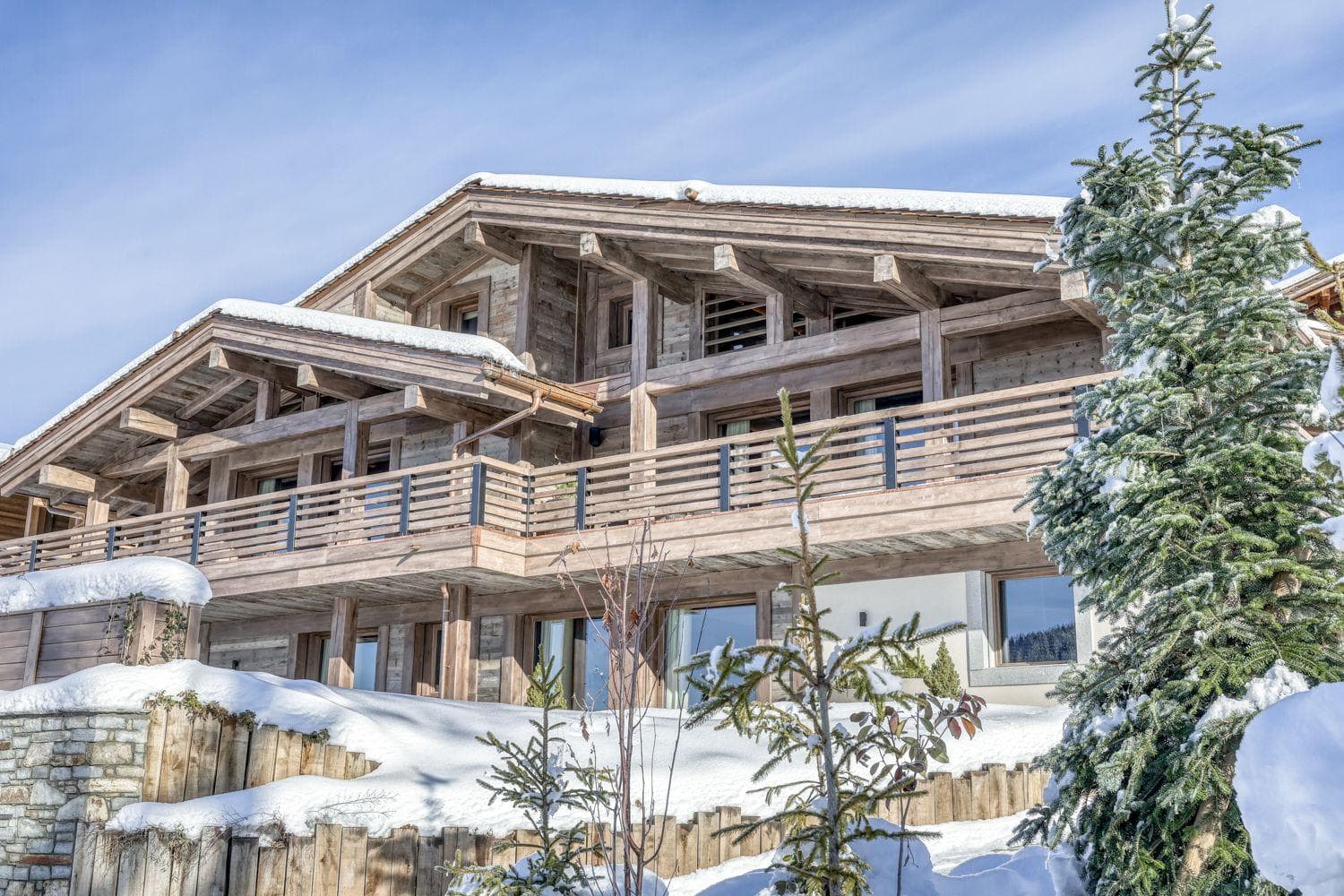 Timber chalet exterior with wraparound balconies and ski-in/ski-out access