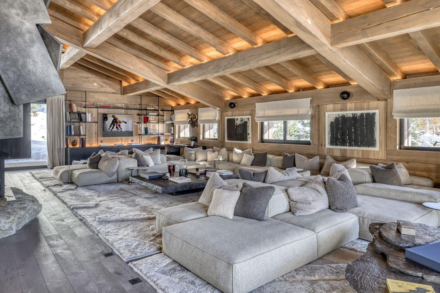 Media room with wood-beam ceilings and modular lounge seating for 15