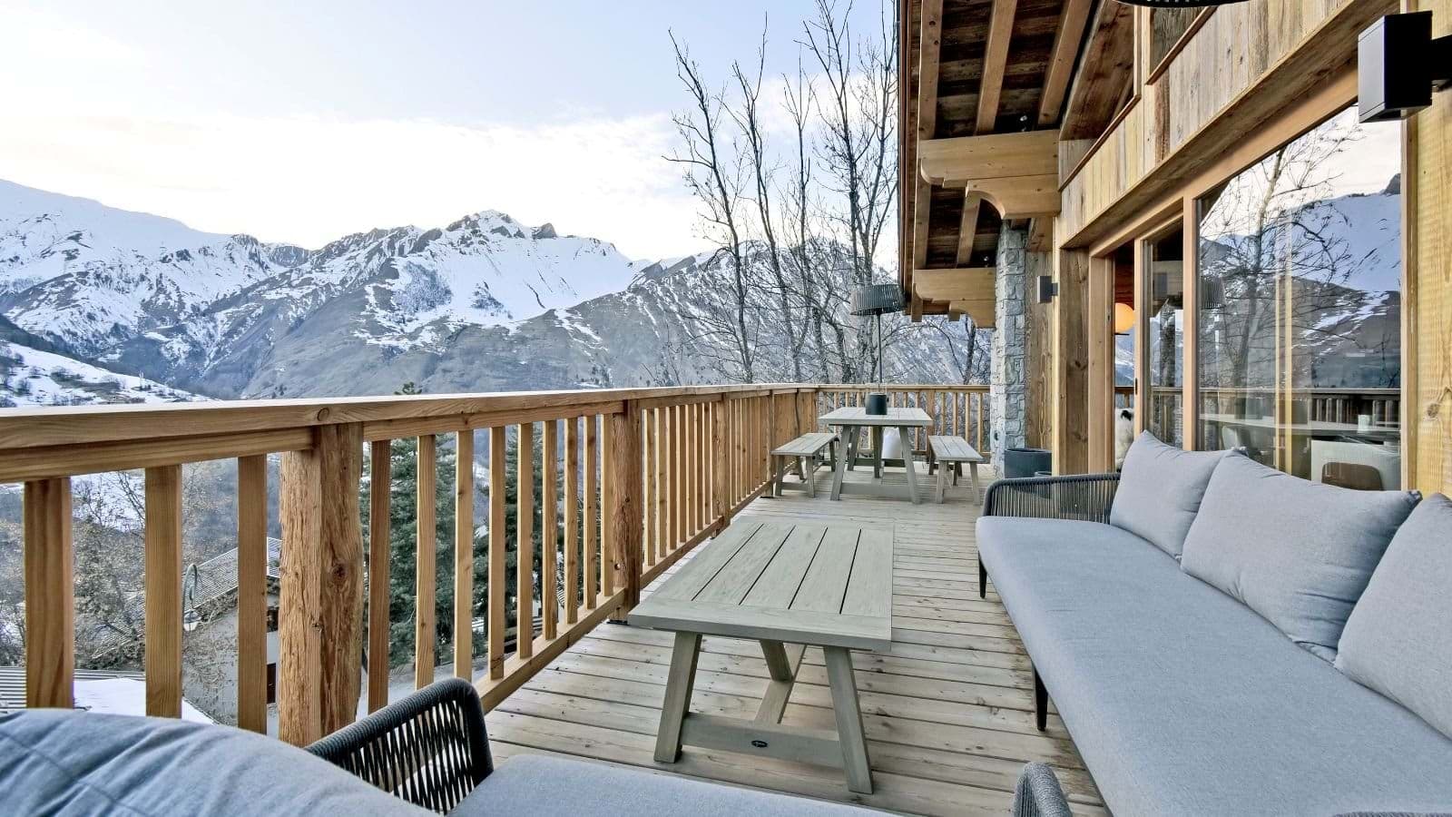 Deck with outdoor dining table and lounge seating; mountain views