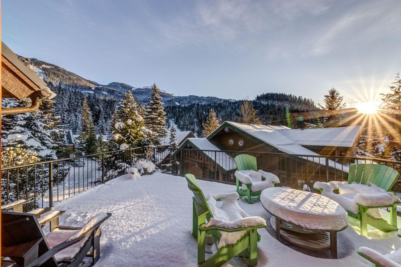 Private deck with Adirondack seating and panoramic mountain sunset views