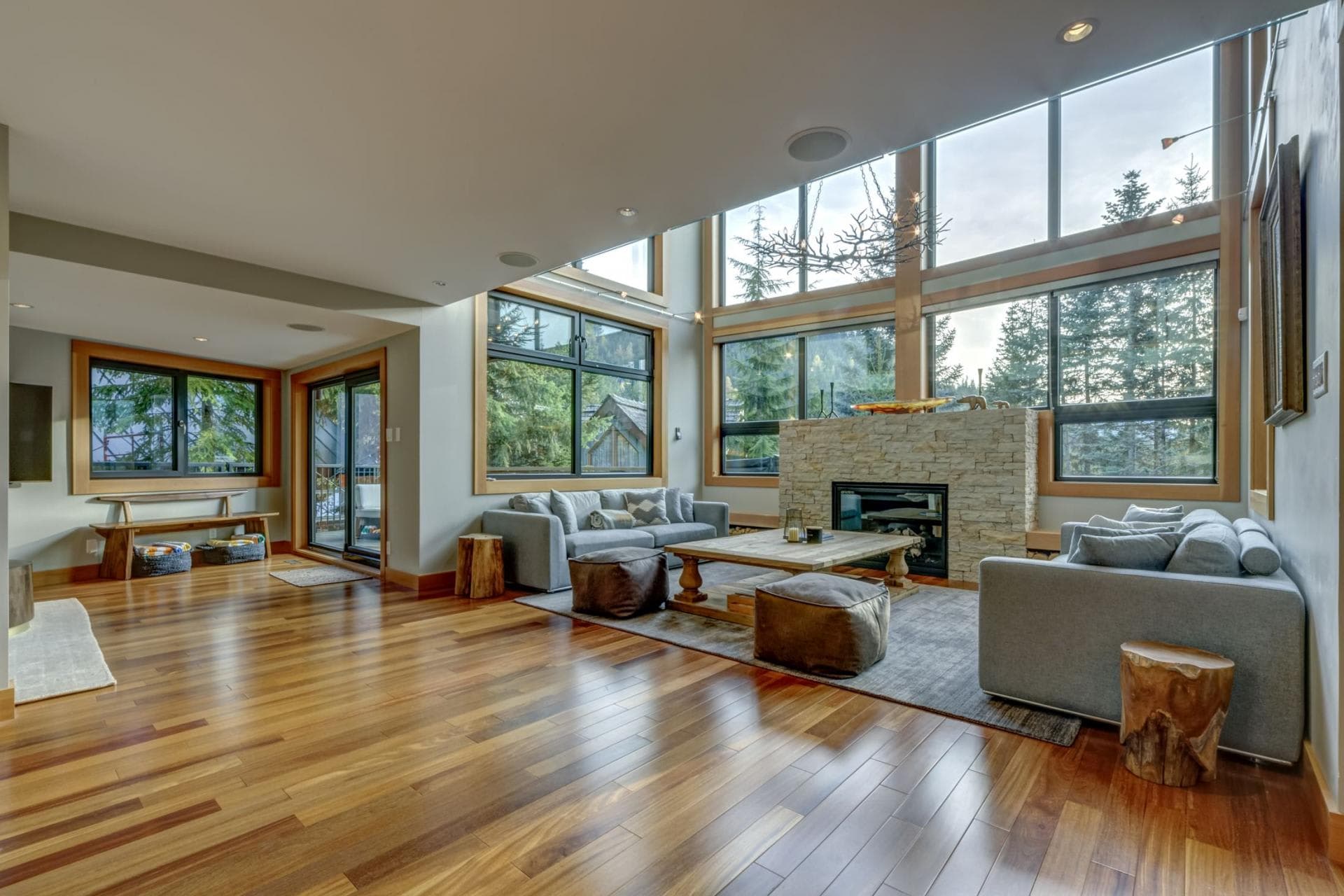 Living area with floor-to-ceiling windows and stone gas fireplace