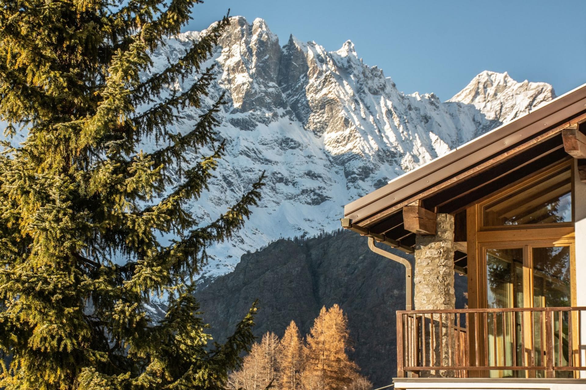 Private balcony with stone pillar and jagged mountain peak view