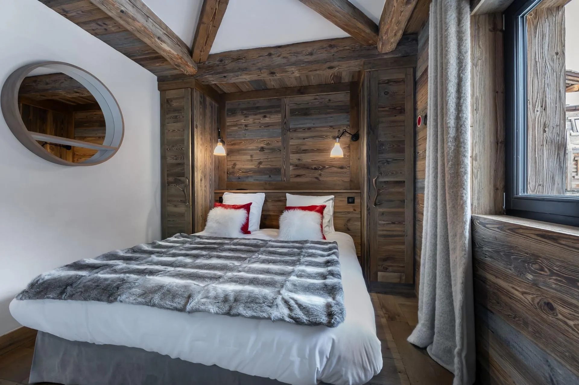 Double bedroom with timber walls and window
