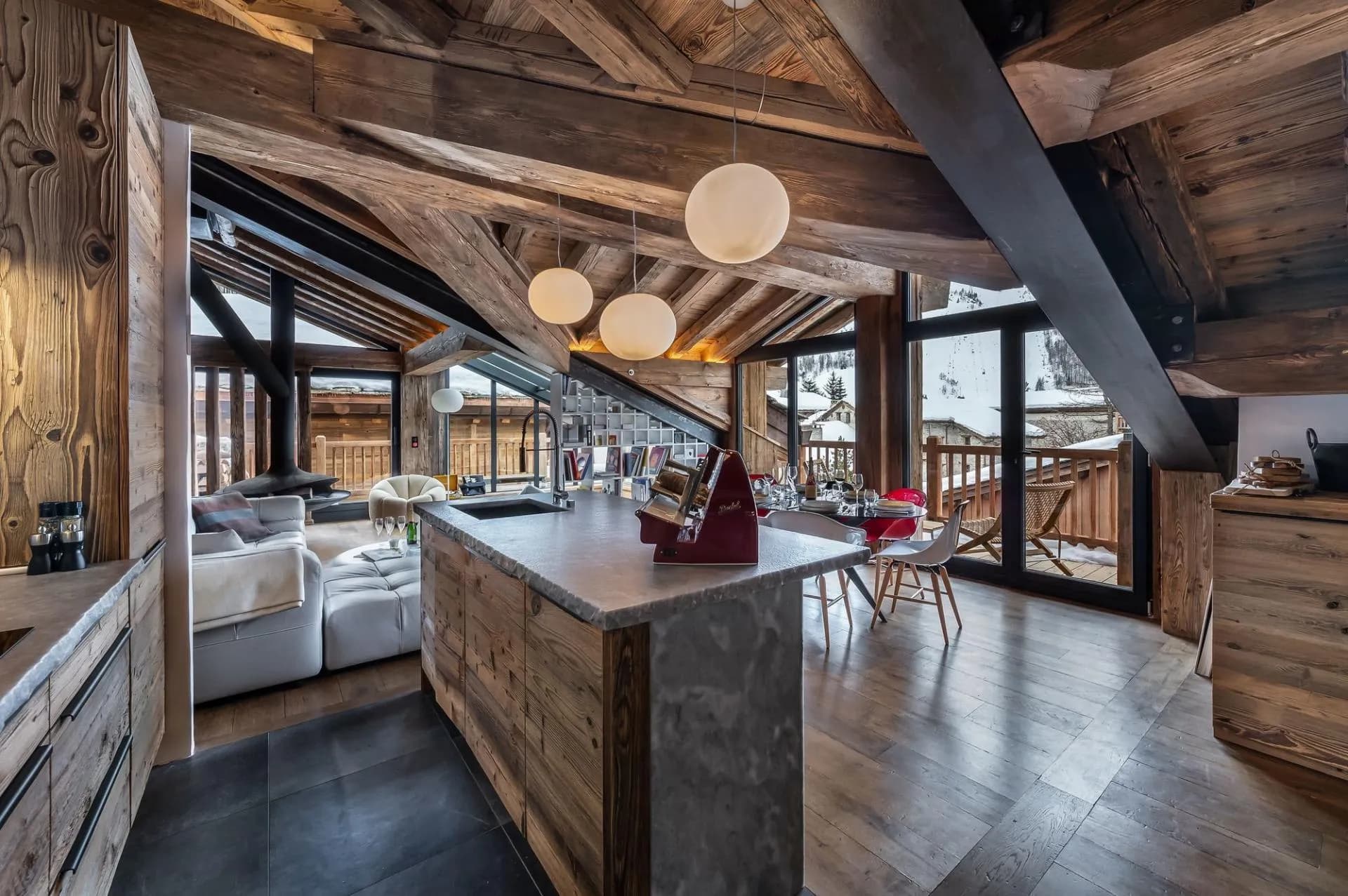 Open kitchen and living floor beneath vaulted timber ceiling
