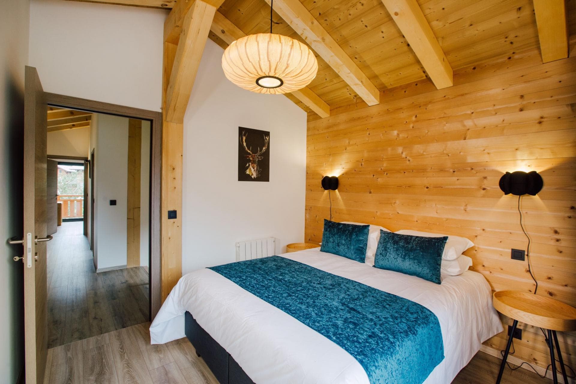 Guest bedroom with king bed and vaulted timber ceilings