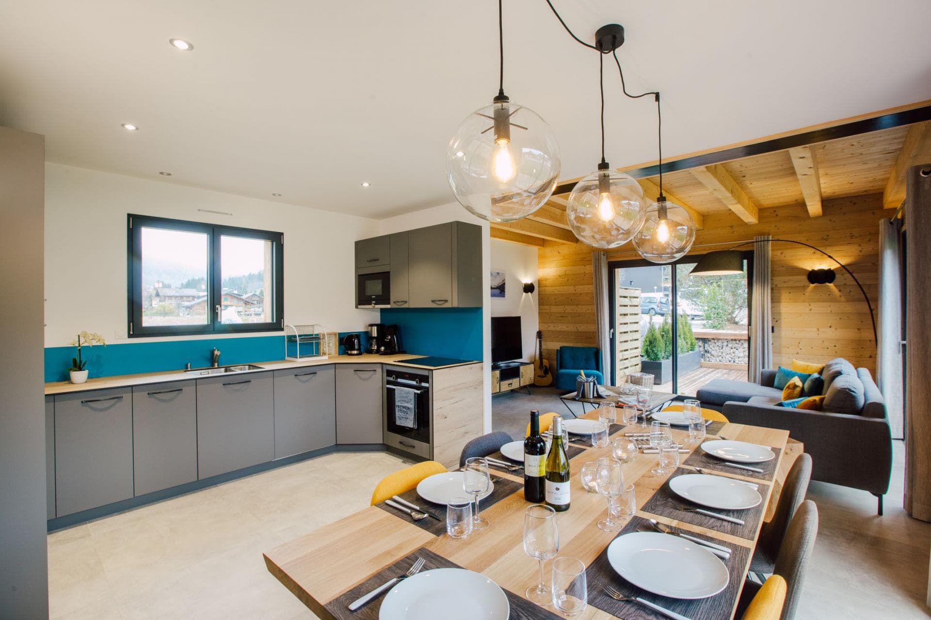 Open-plan dining area with seating for 6; kitchen includes induction stove and oven