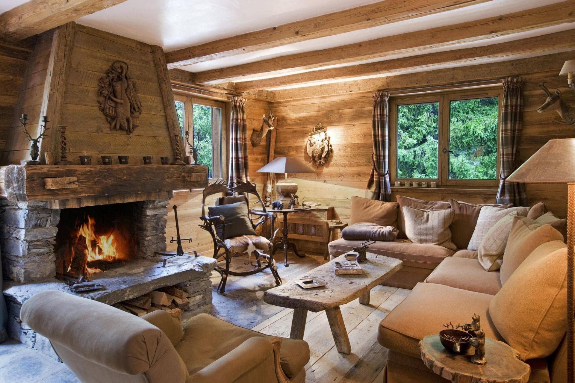 Living area with wood-burning stone fireplace and exposed timber beams