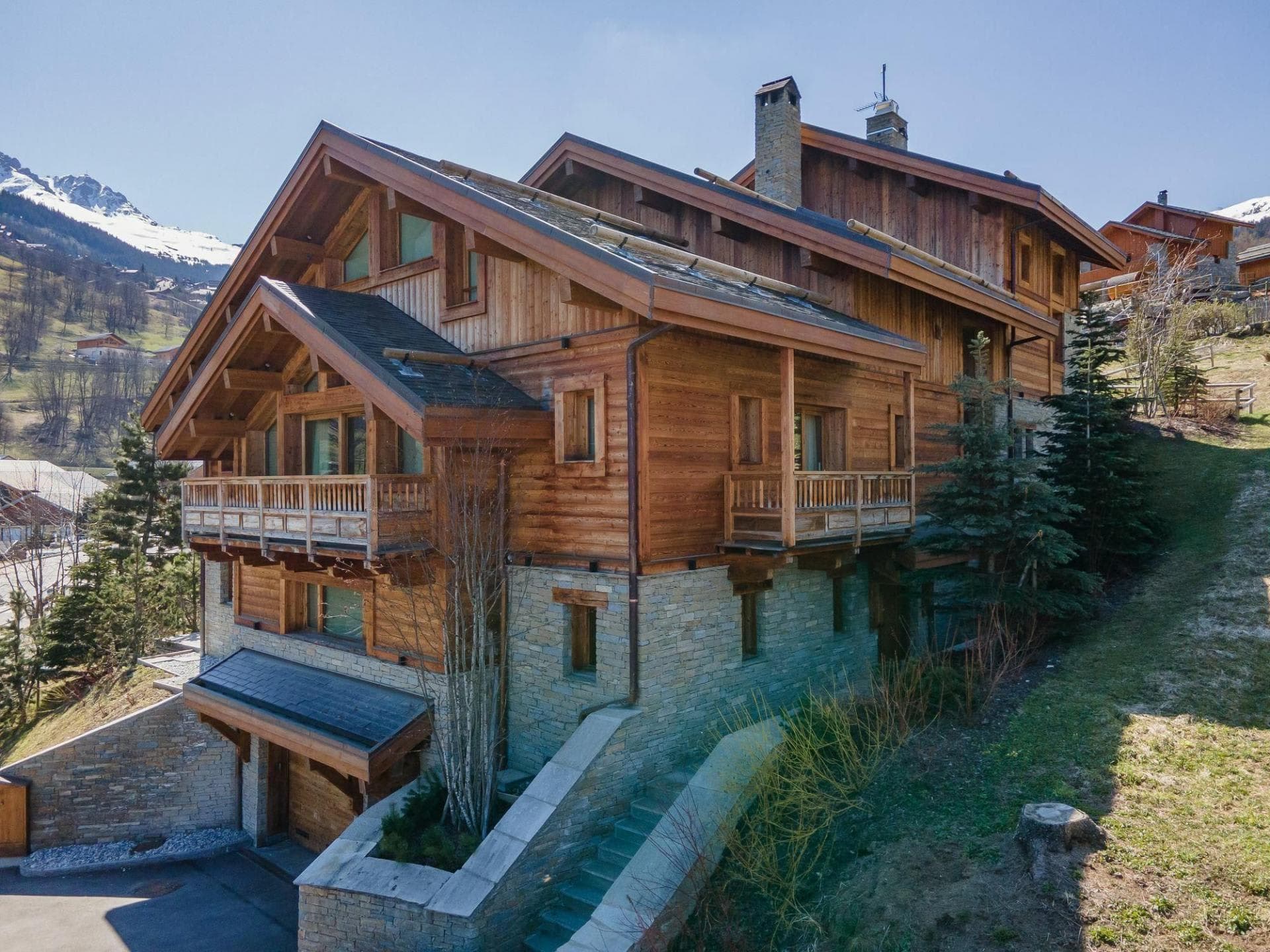 Ski-in chalet exterior with multi-level balconies and private garage access