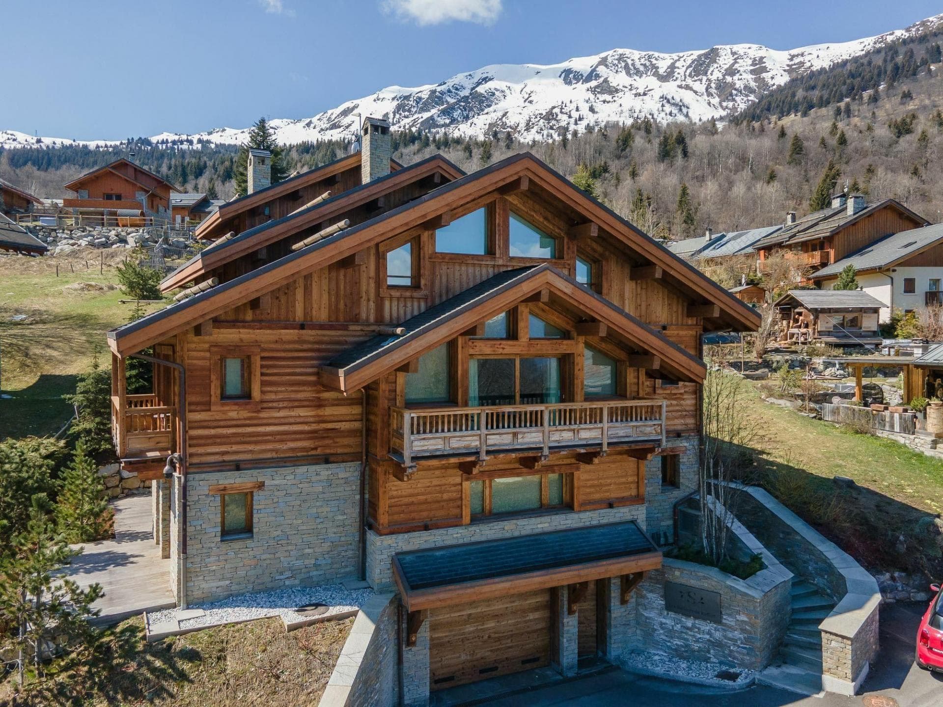 Ski-in chalet with mountain views, private garage, and tiered stone terrace