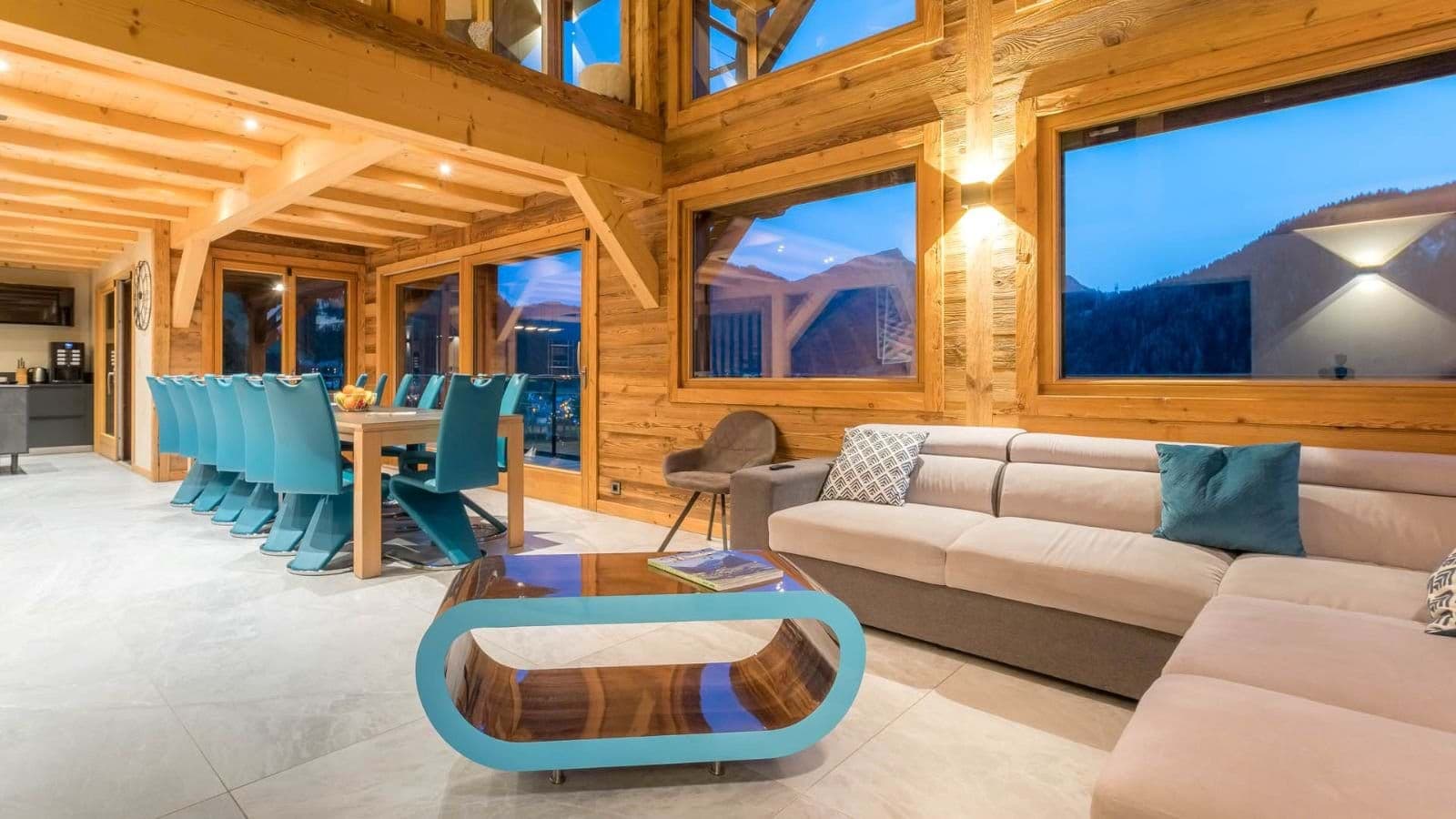 Open-plan living area with 10-person dining table and mountain views
