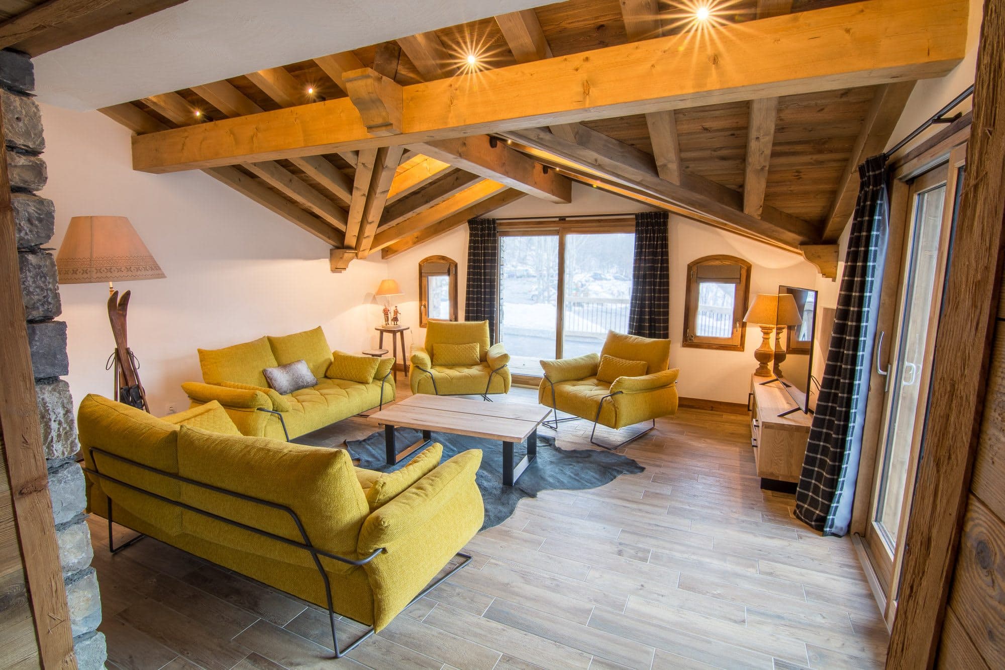 Living area with vaulted timber ceilings and seating for 8