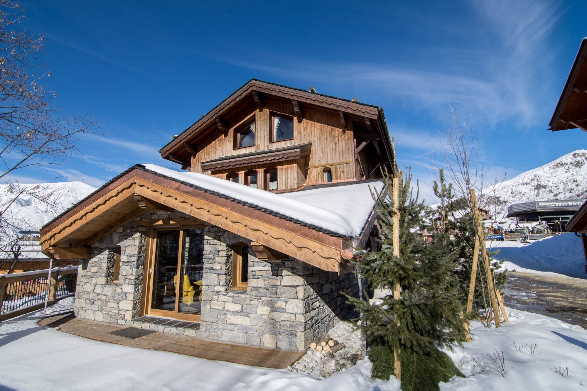 Ski-in/ski-out chalet exterior with stone facade and direct lift access