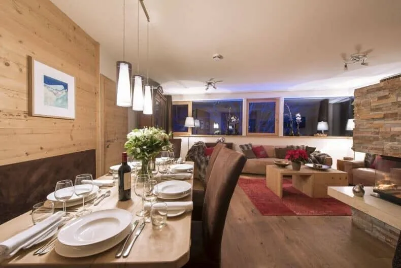 Dining table seats 8; open-plan layout with living room fireplace
