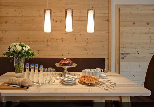 Dining area with light wood table and built-in bench seating