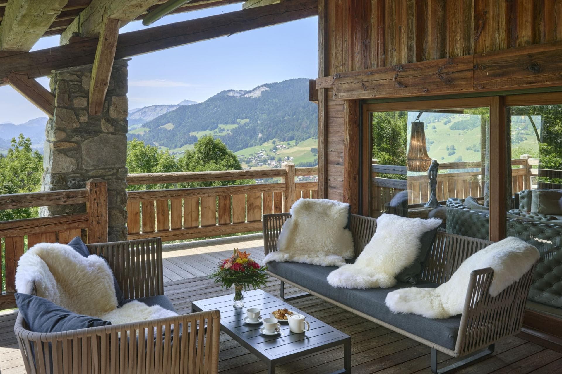 Covered balcony with lounge seating and panoramic mountain valley views