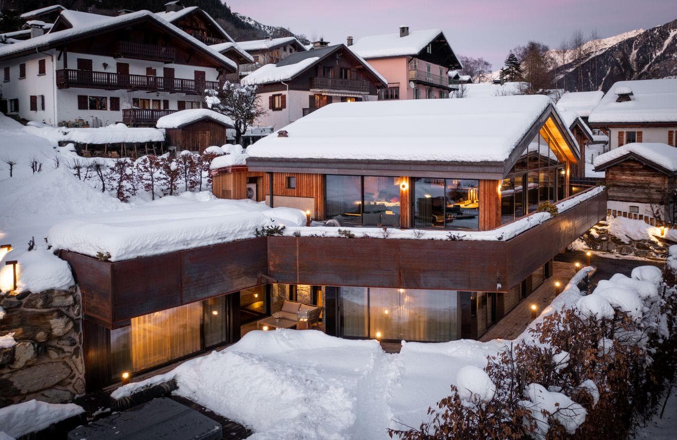 Chalet exterior with multi-level terraces and floor-to-ceiling windows
