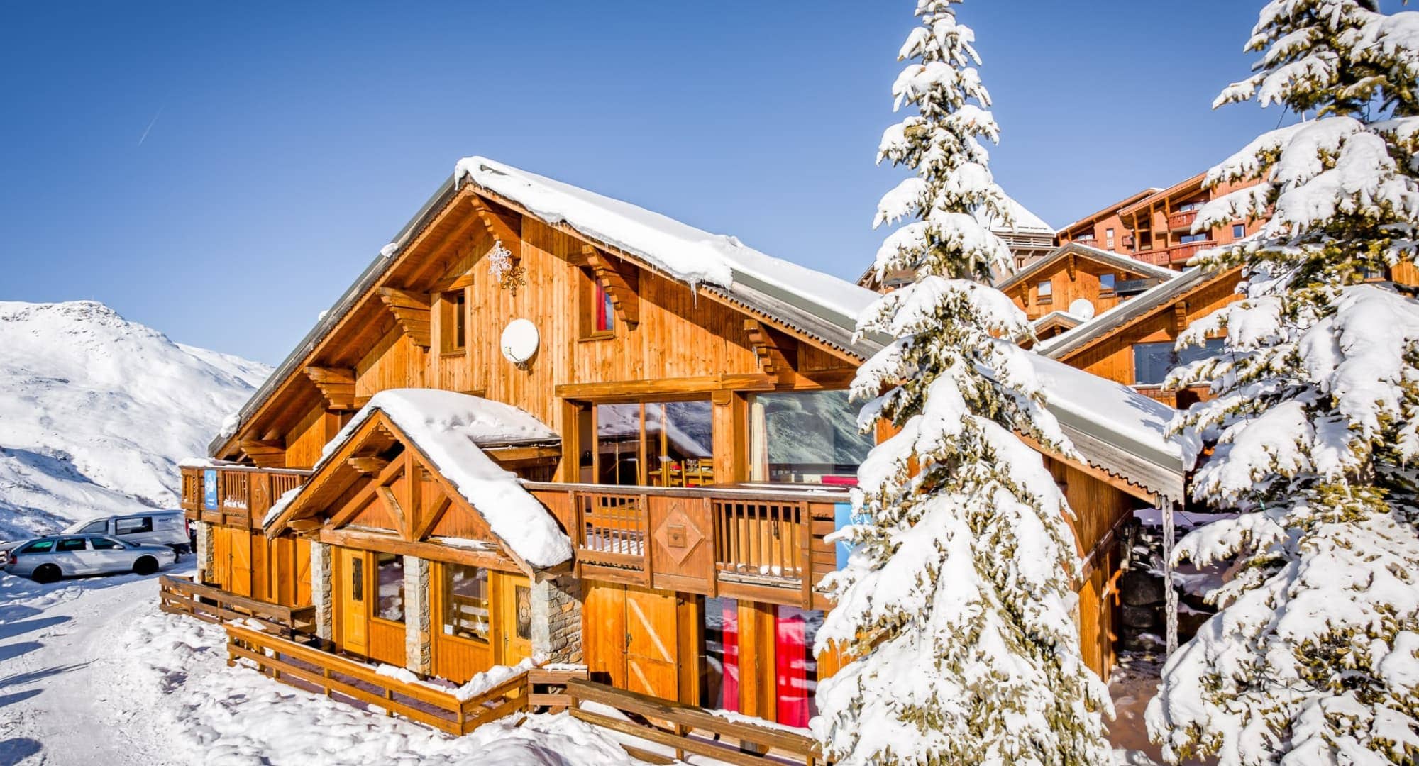 Timber chalet exterior with private balcony and mountain views