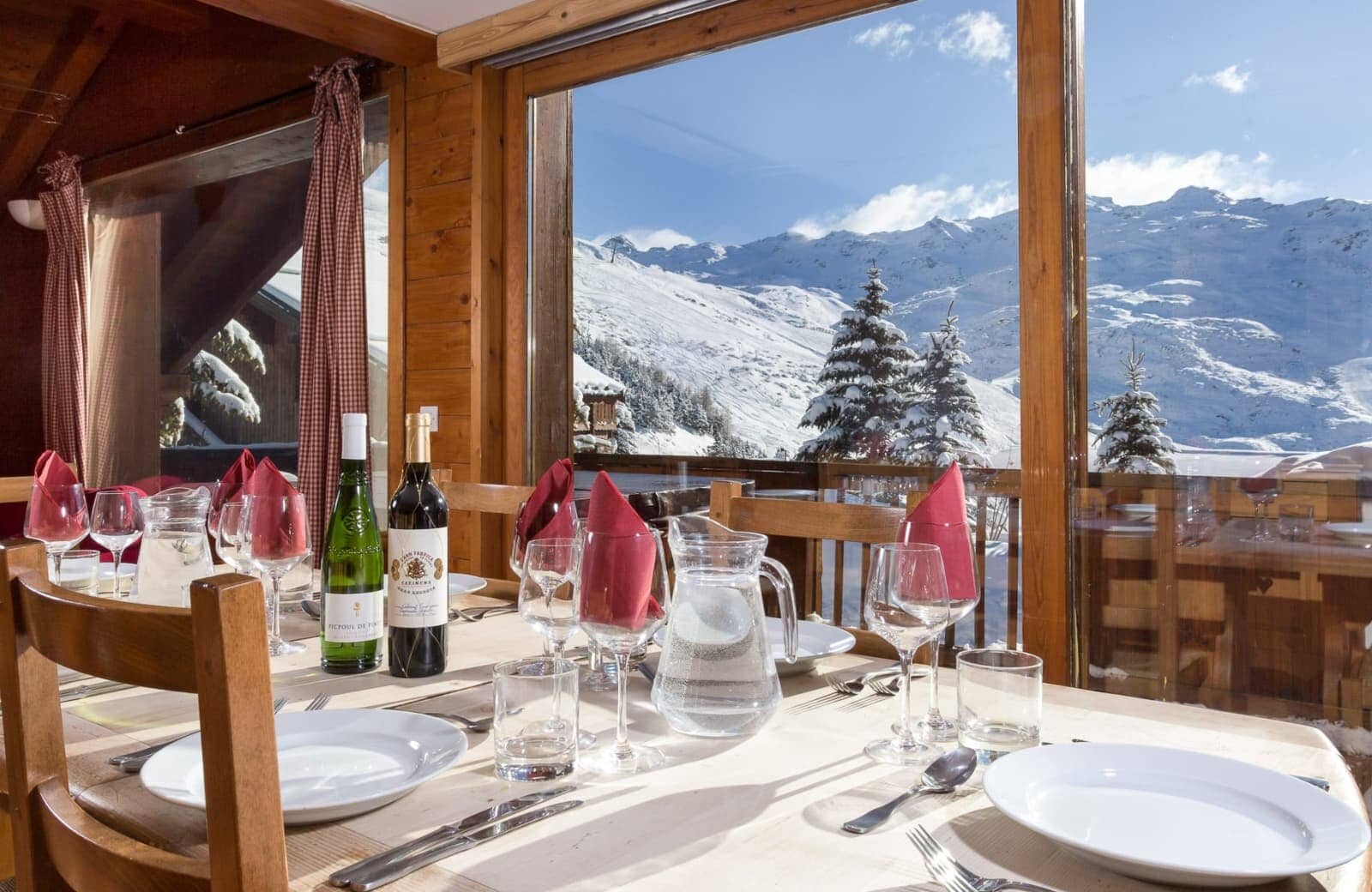Dining area with mountain views through large floor-to-ceiling windows
