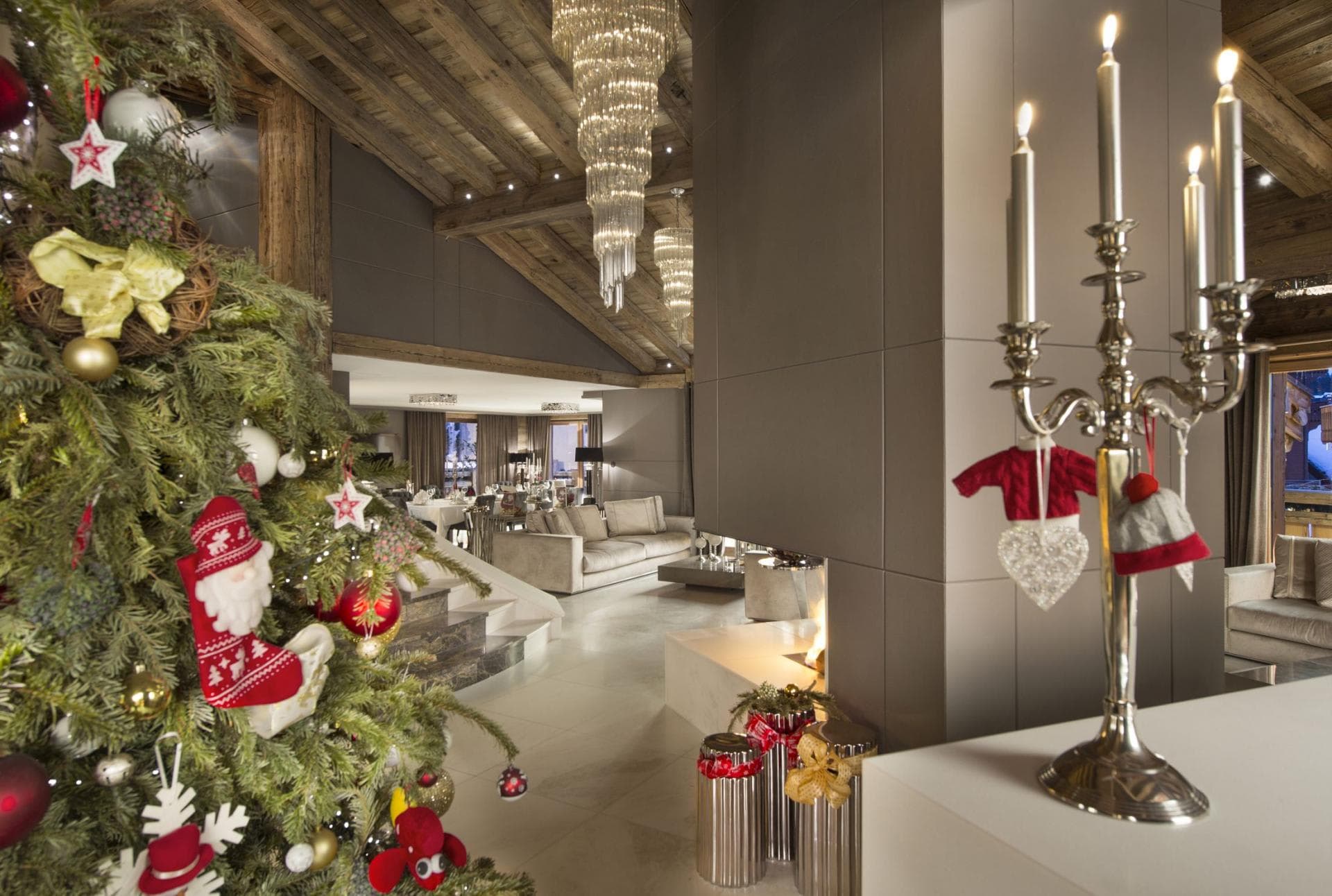 Open-plan living area with double-sided gas fireplace and vaulted timber ceilings