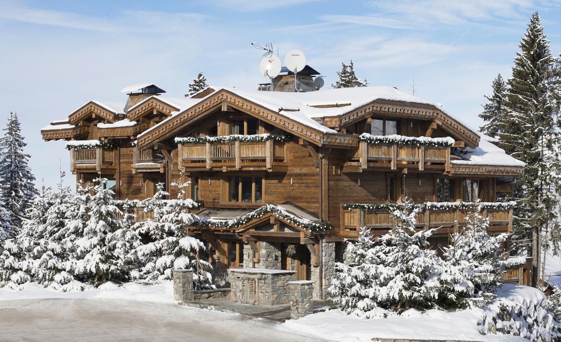 Ski-in chalet with private balconies and stone-entry courtyard