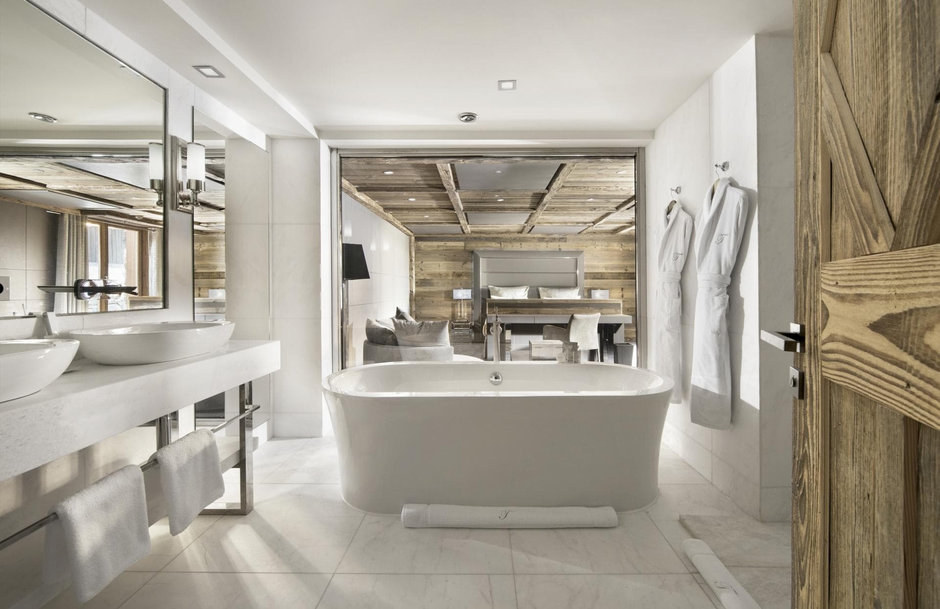 En suite bathroom with freestanding tub and dual vessel sinks