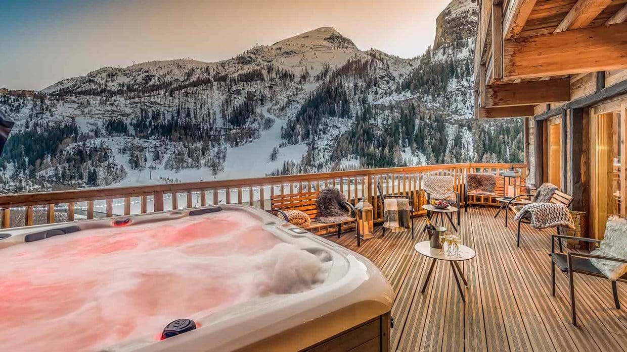 Private deck with heated spa and direct ski slope views