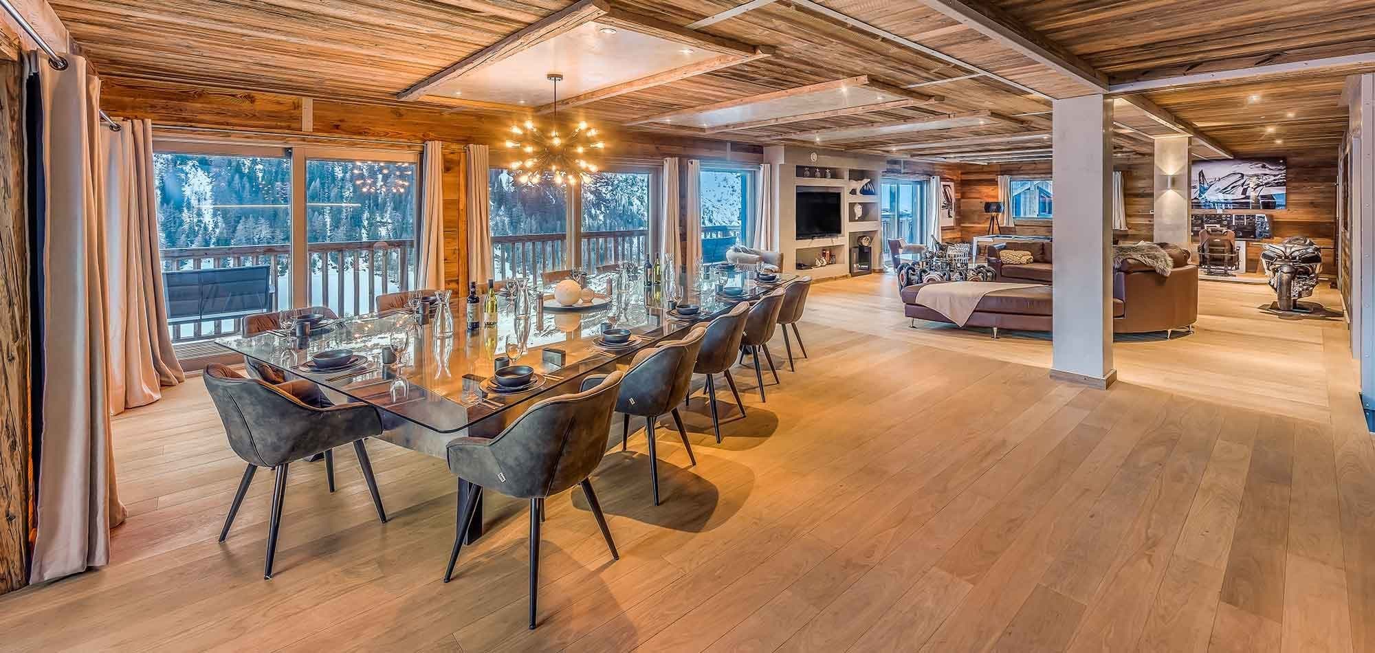 Open-plan dining area seats 12 with glass table and mountain views