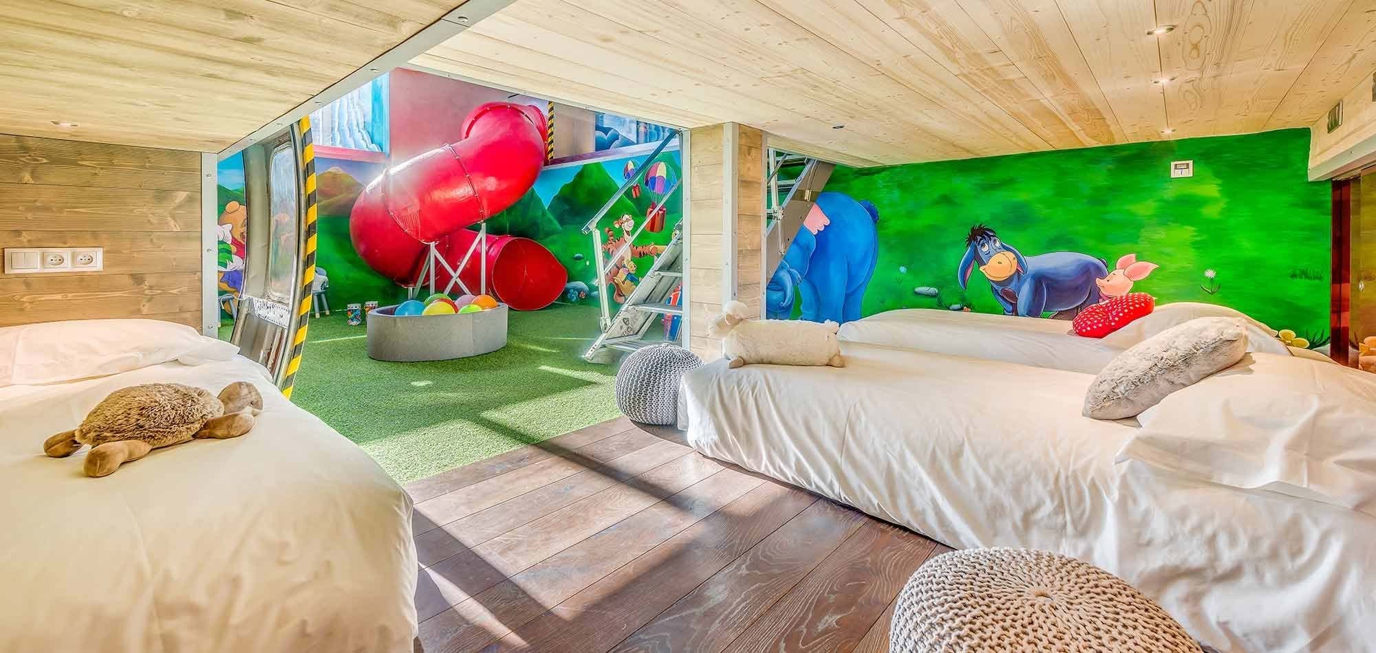 Children's bedroom with floor mattresses and indoor slide access