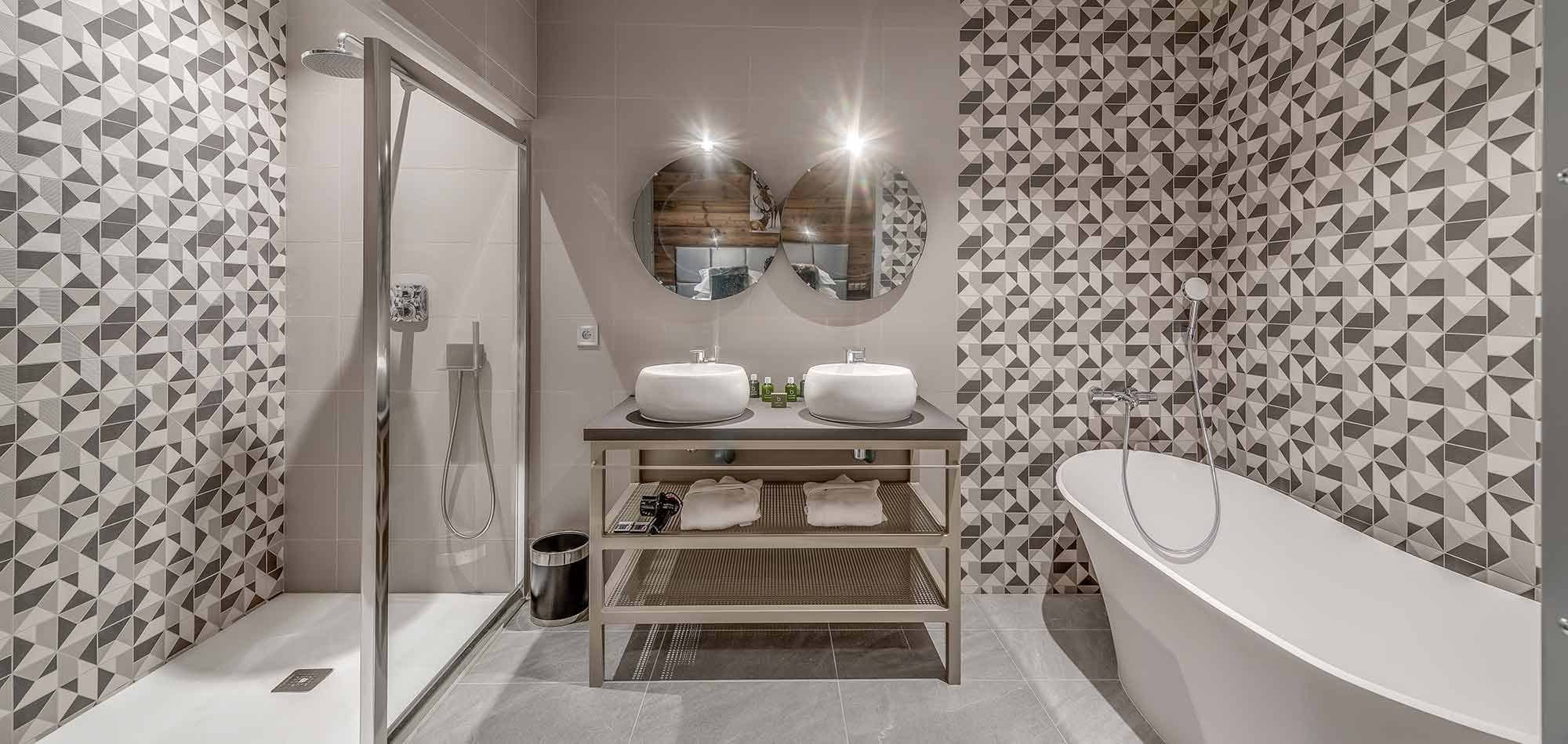 Bathroom with dual vessel sinks, walk-in shower, and freestanding soaking tub