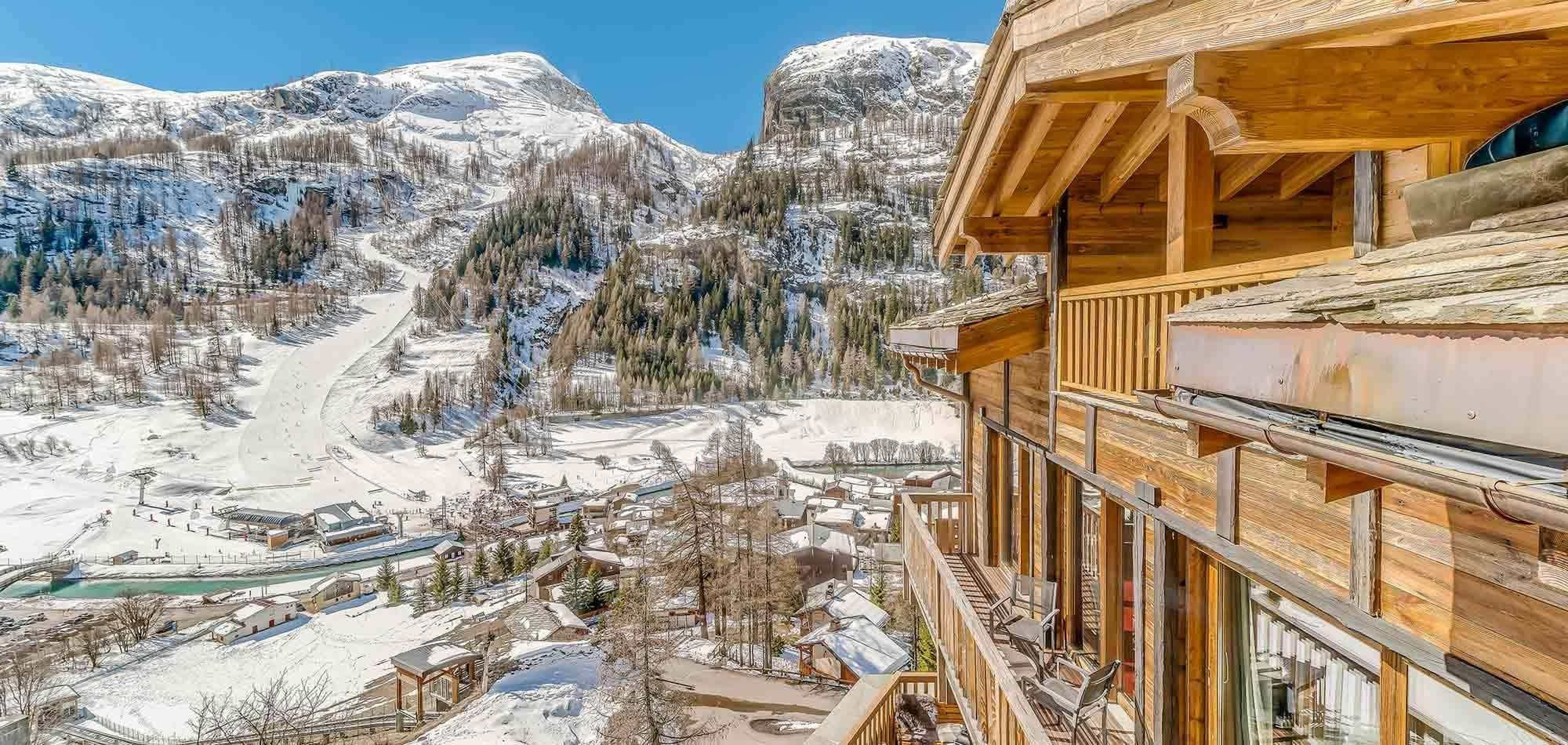 Private balcony with seating overlooking ski runs and valley