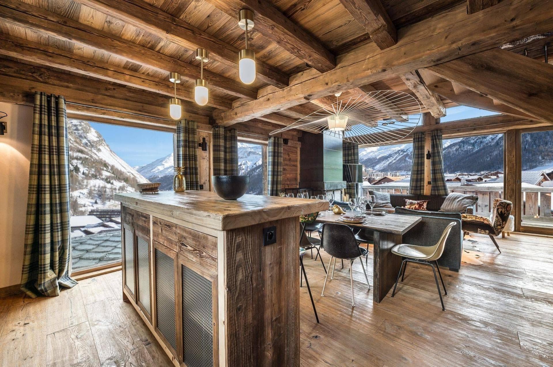 Open-plan living area with reclaimed wood finishes and panoramic mountain views