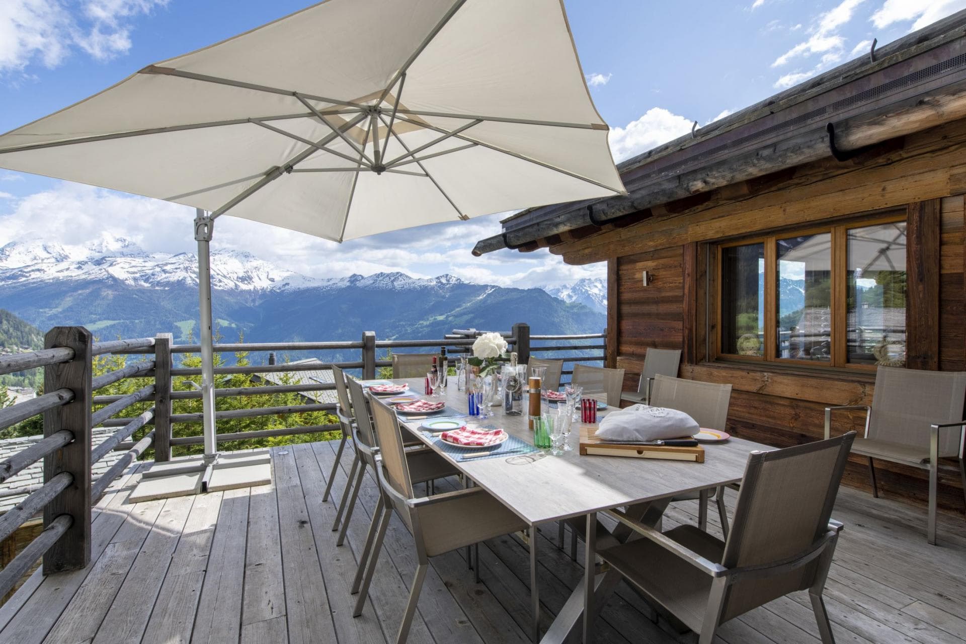 Chalet balcony dining table for 10 with mountain views and umbrella