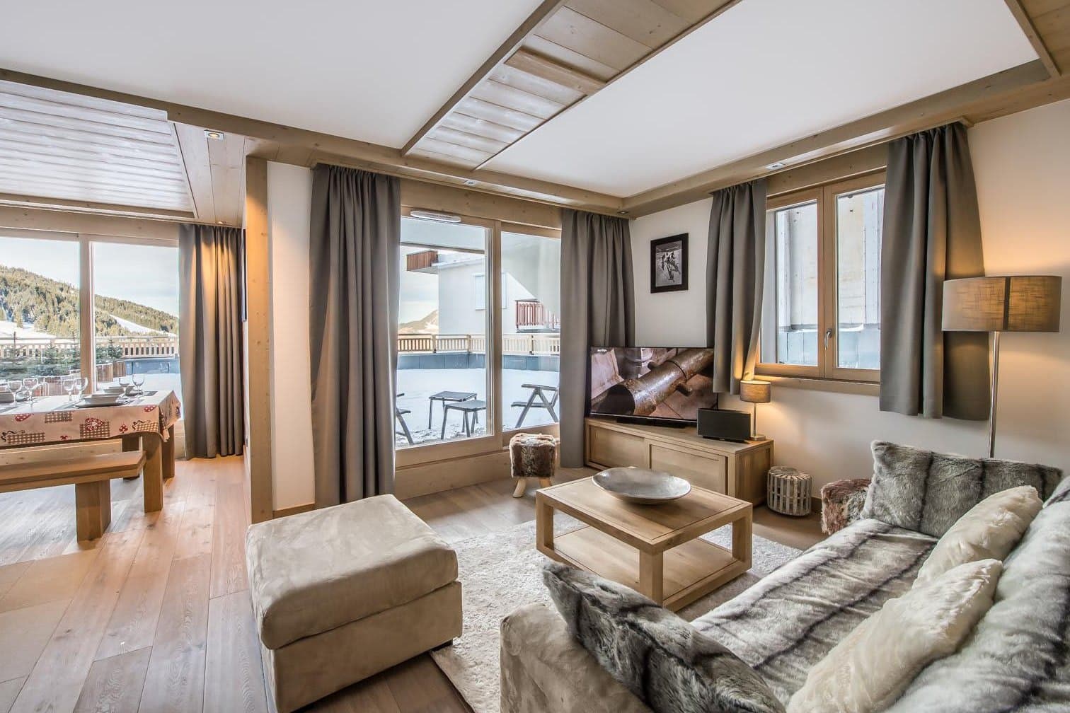 Living area with terrace access and views of the ski slopes