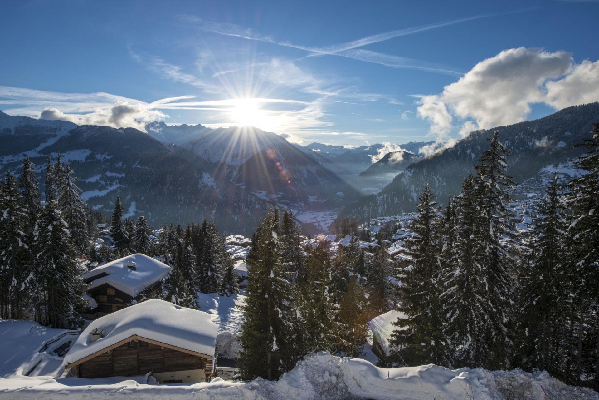 South-facing alpine views overlooking snow-covered chalets and the valley below