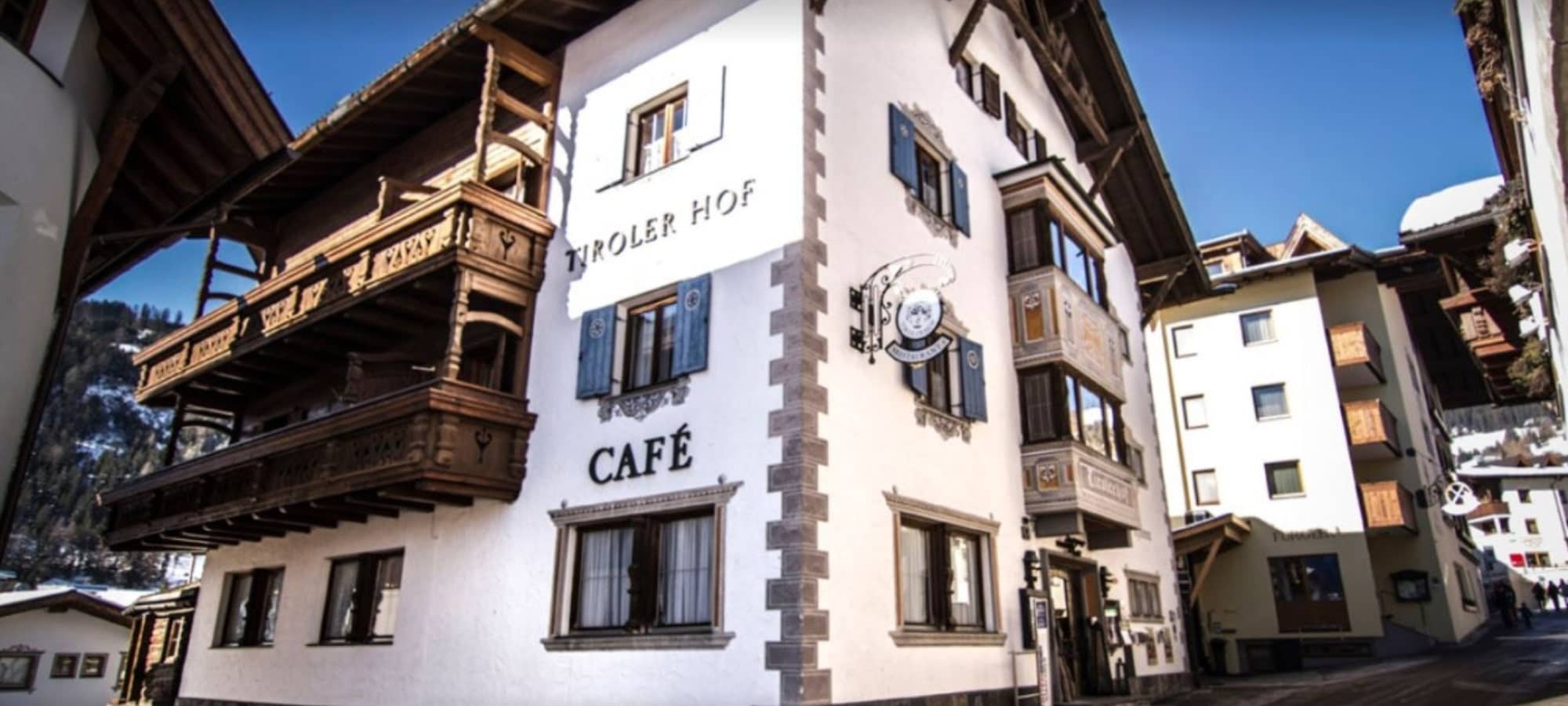 Tiroler Hof exterior featuring on-site café and traditional carved wooden balconies