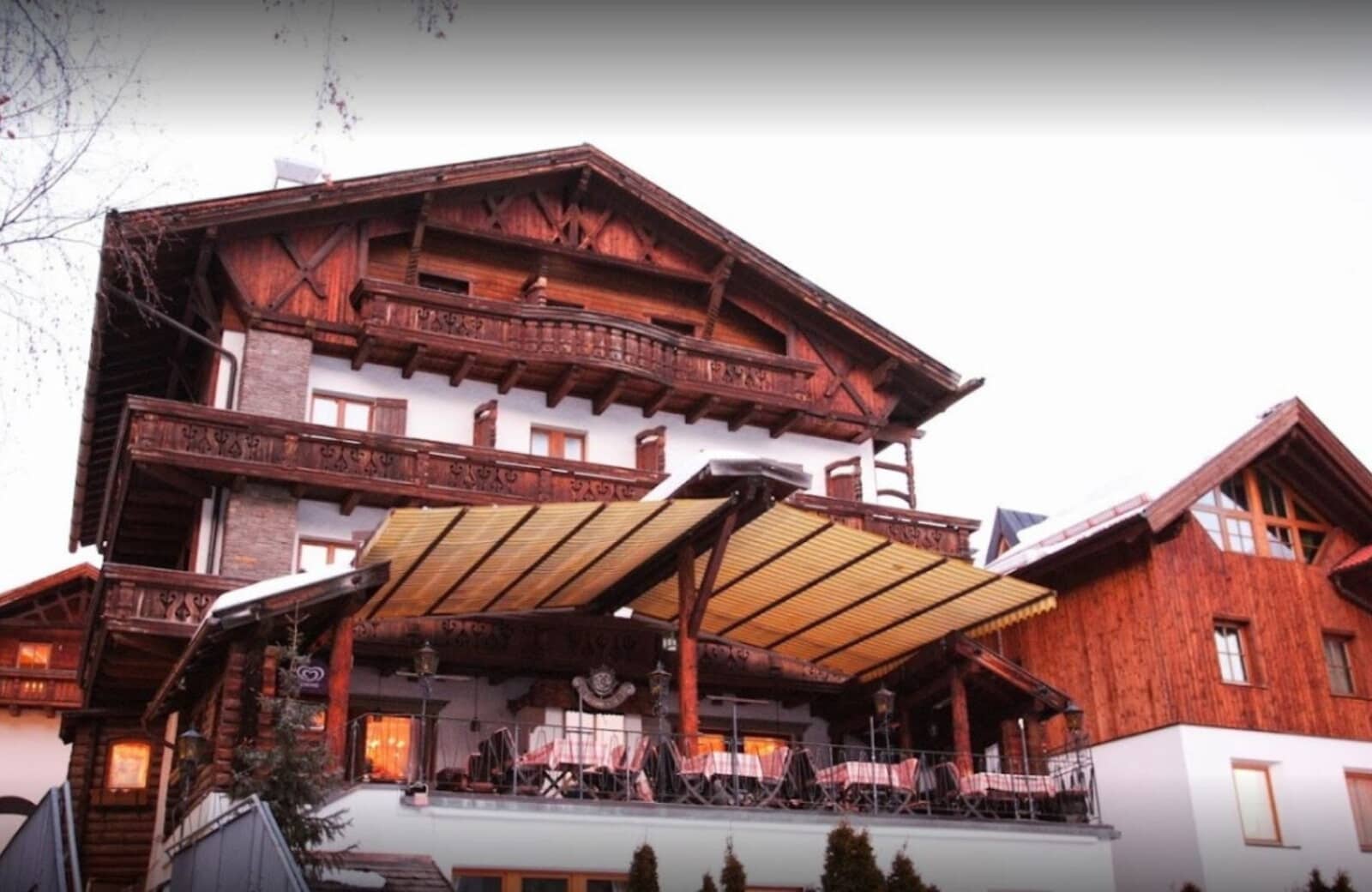 Chalet exterior with retractable awning and outdoor dining terrace