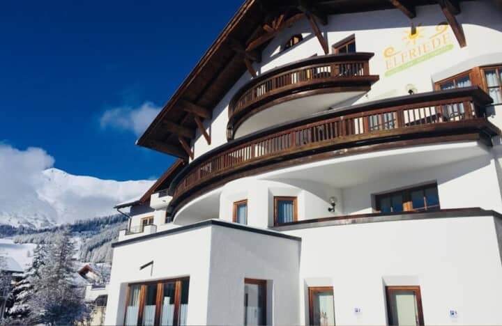 Chalet exterior with multiple private balconies and mountain views