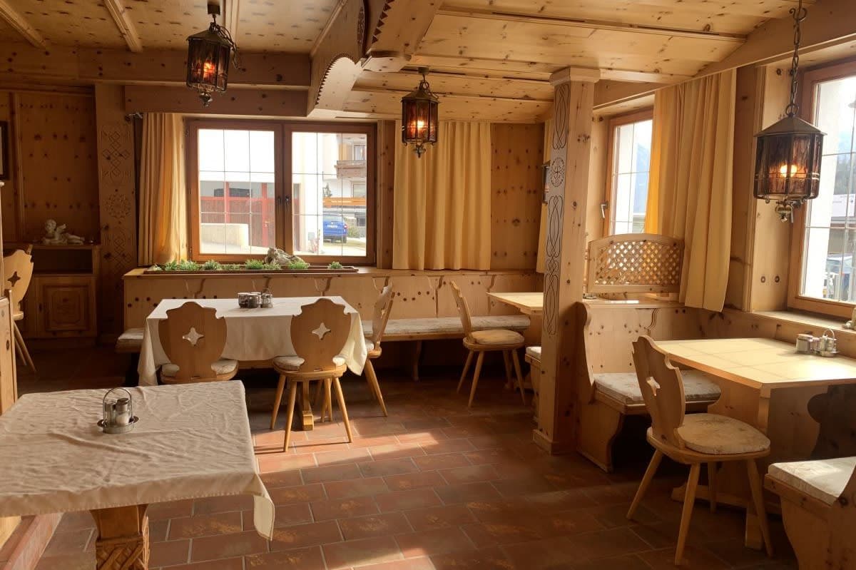 Dining area with pine wood paneling and booth seating