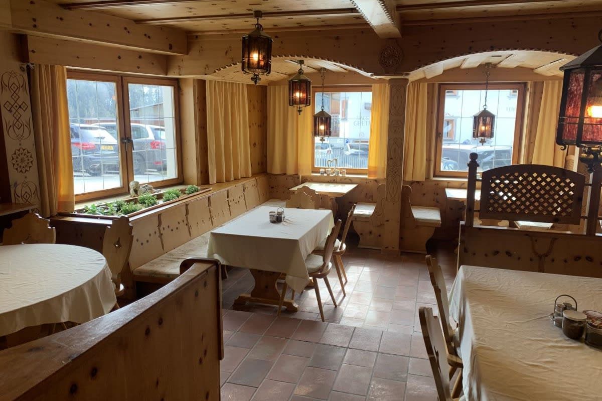 Dining area with booth seating and traditional wood paneling